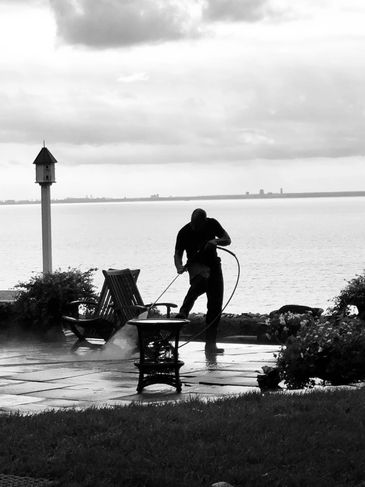 Four Seasons power washing a waterfront stone patio